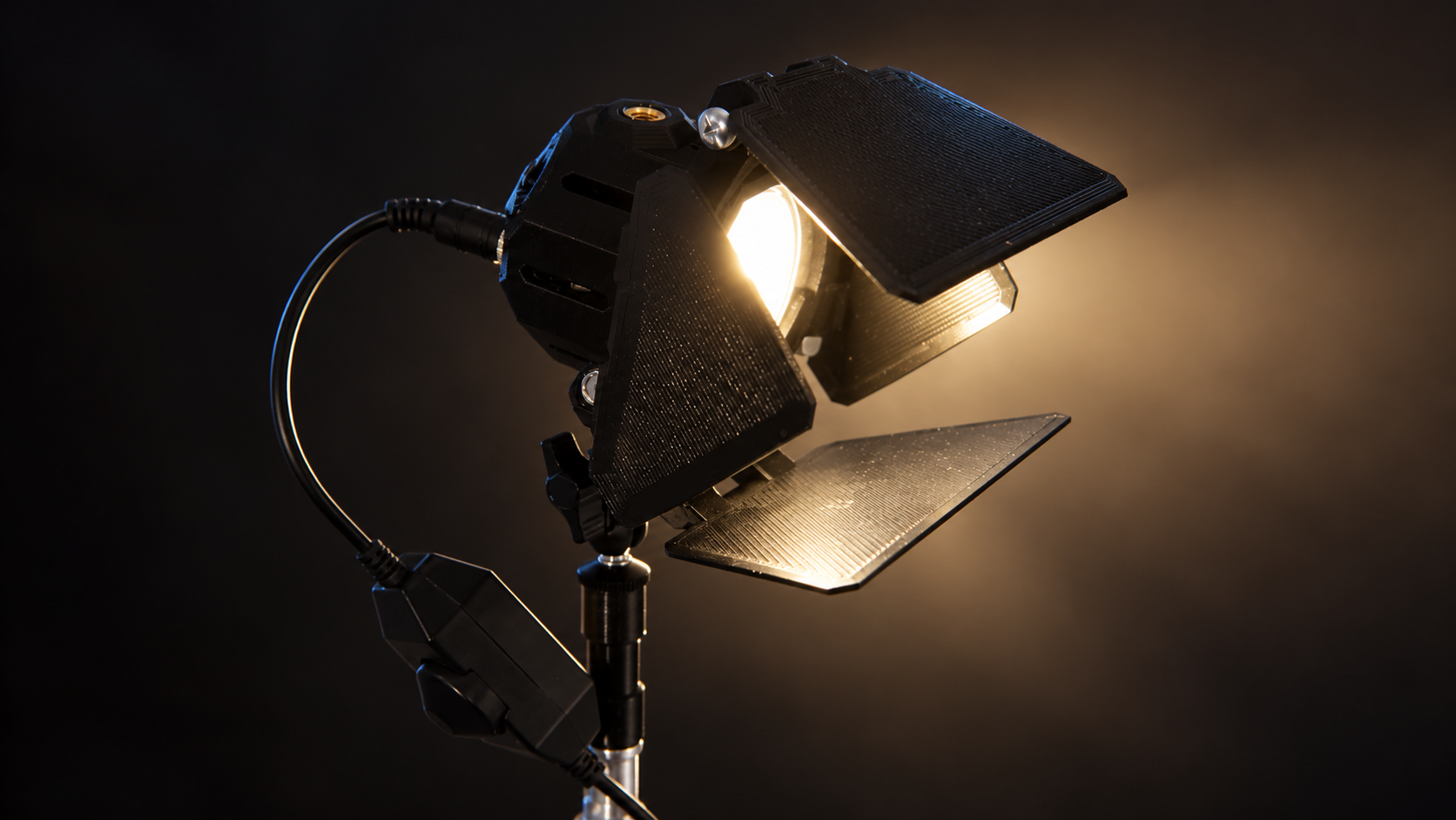 MiniCine Creator Edition light with barn doors against a dark studio background